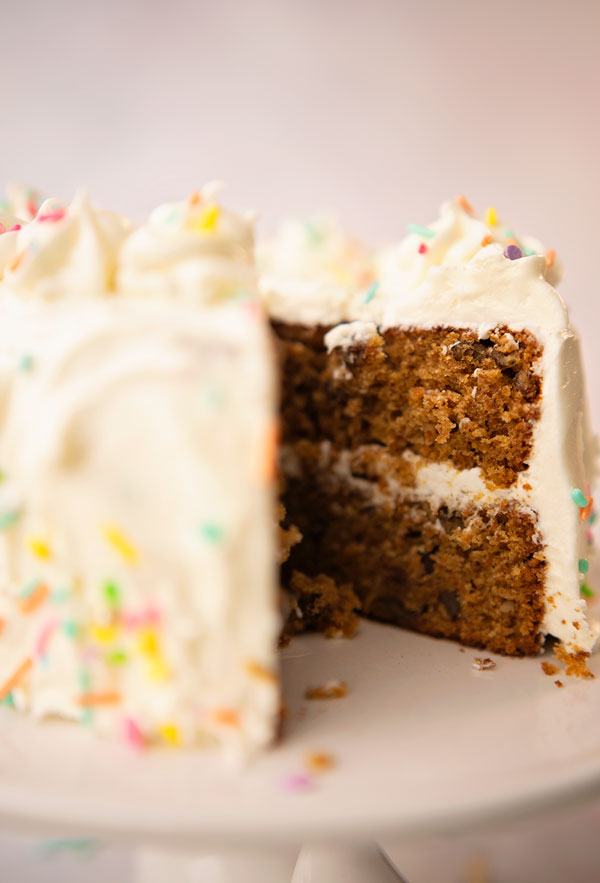a carrot cake missing a slice showing the layers