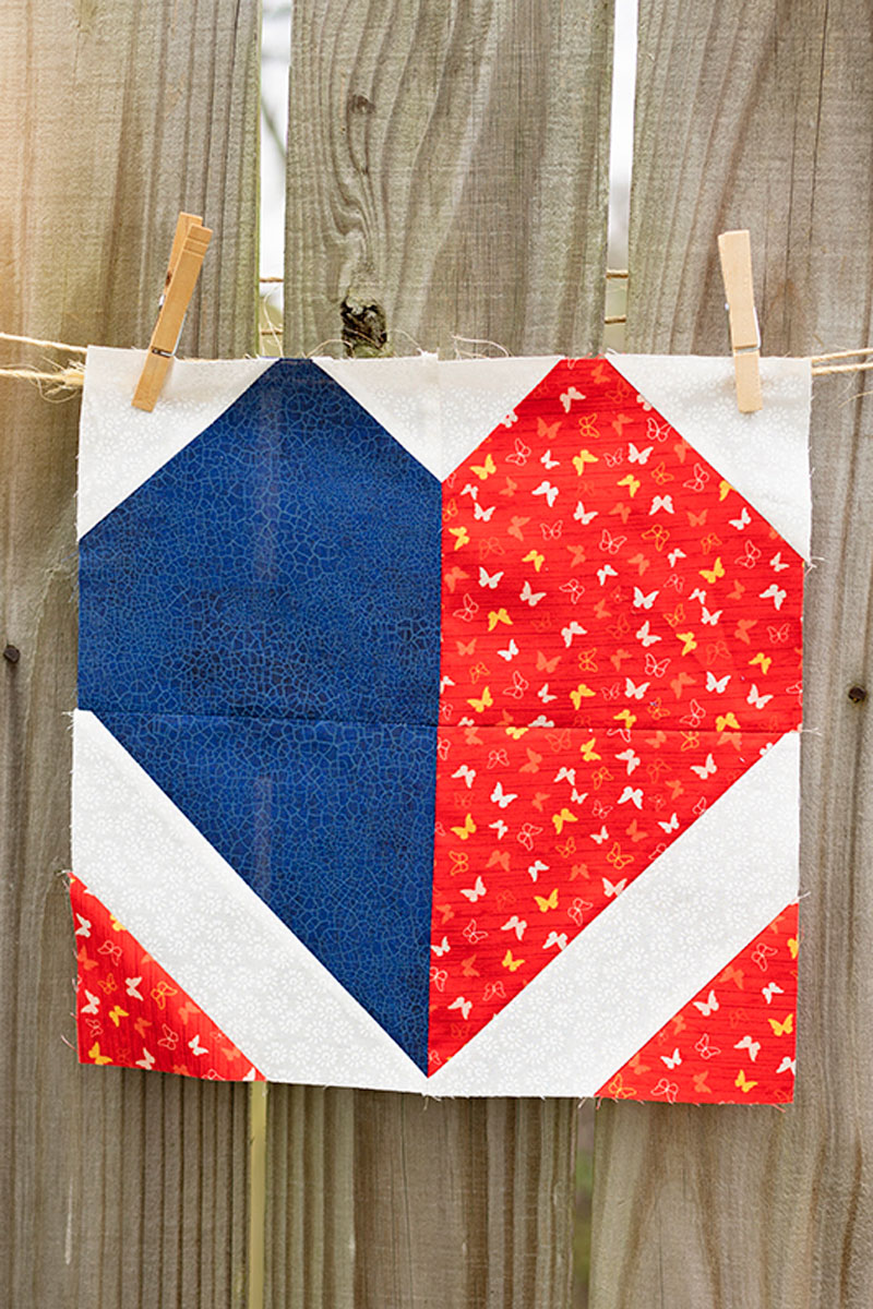 finished quilt block displayed on a rustic fence