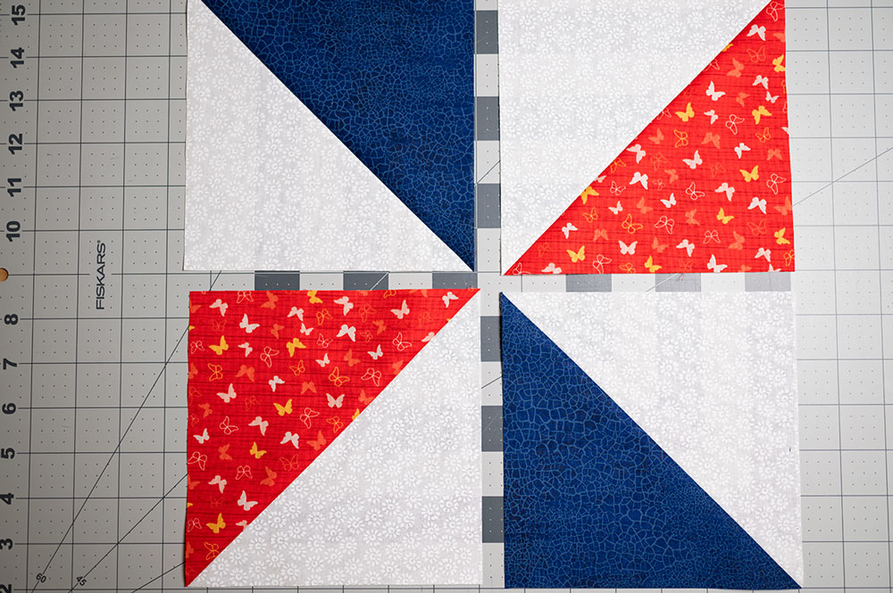 half square triangles laid out for piecing