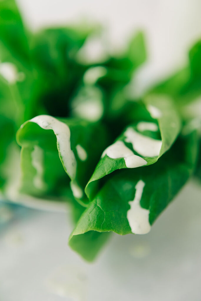 closeup of salad dressing on fresh lettuce