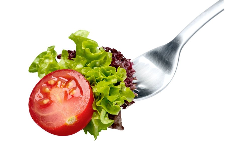 a fork filled with fresh salad