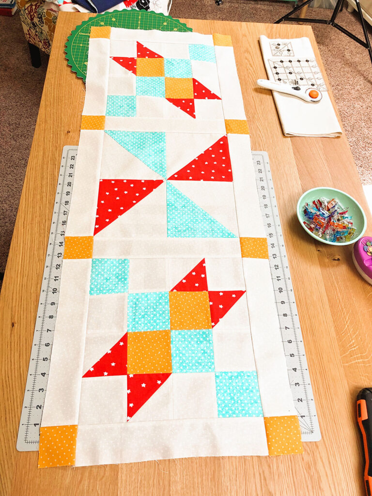 colorful table runner on a pin table top