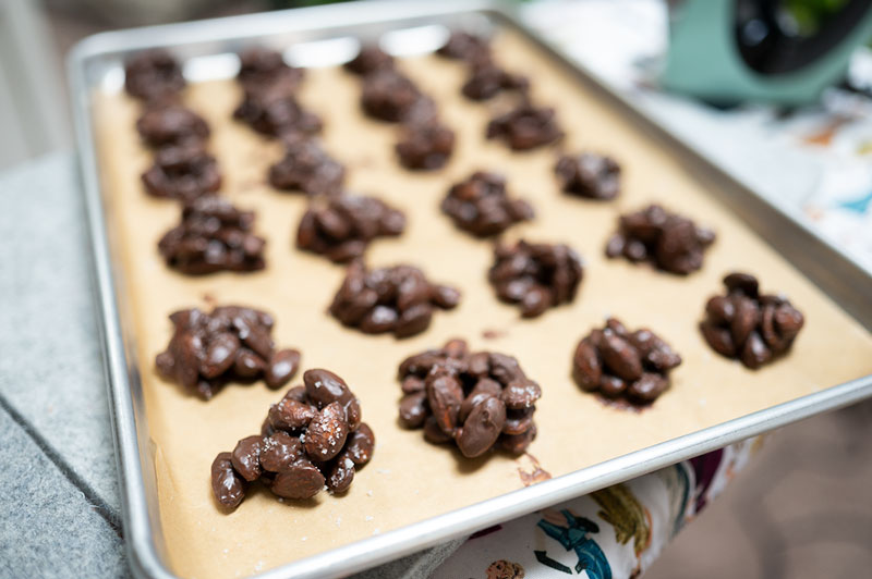 chocolate covered nut clusters on a tray