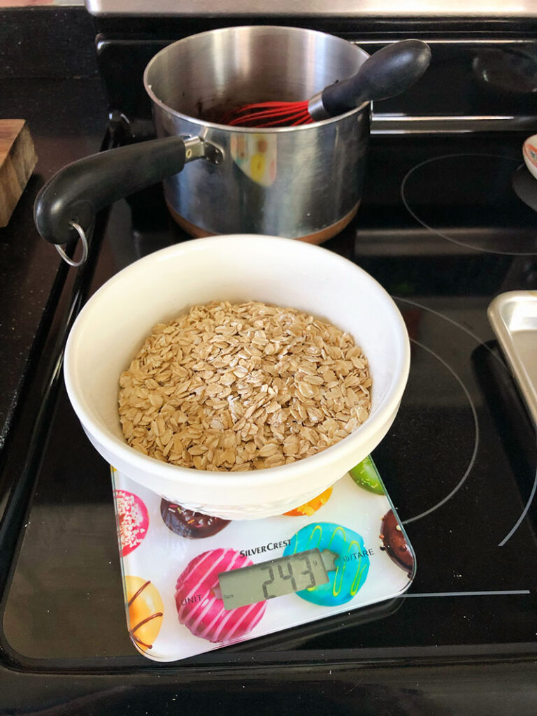 rolled oats in a white bowl measured out for use