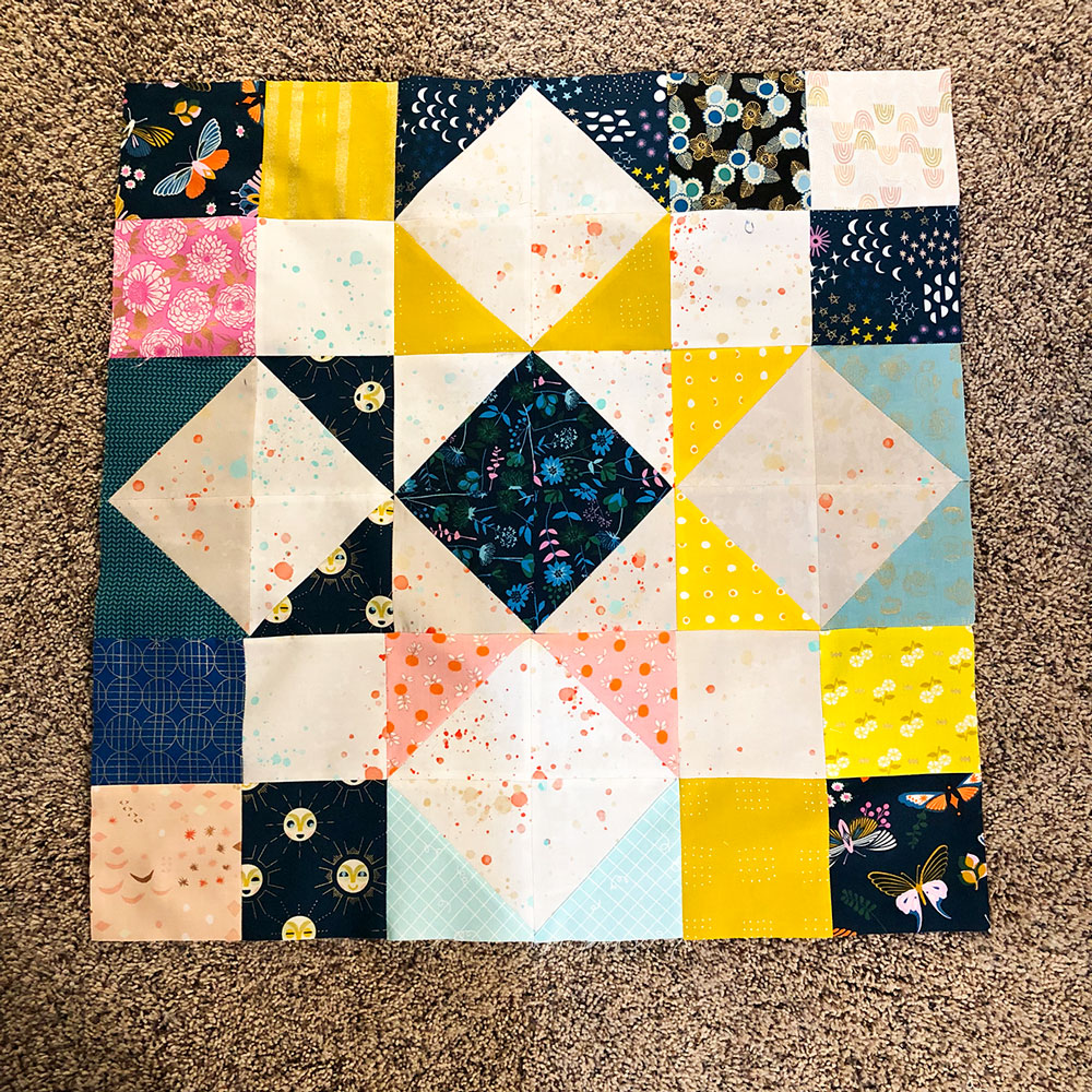 A complicated quilt block design laid on the floor