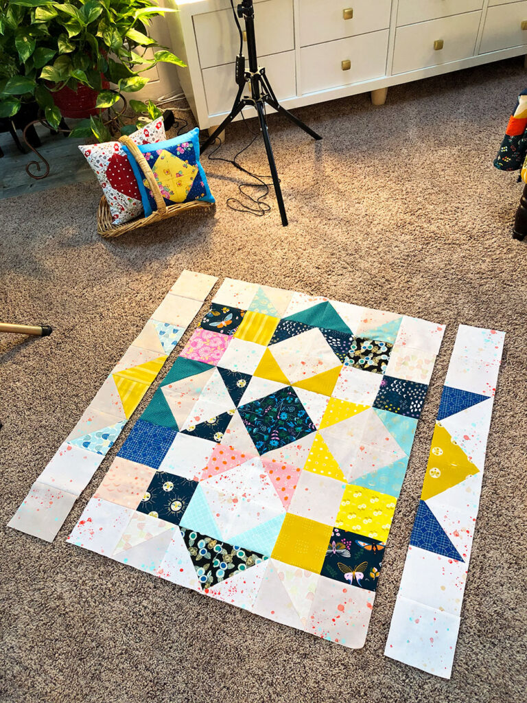 the quilt in process laid out on the floor