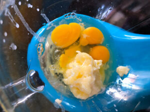 mixing bowl with butter and eggs ready to be combined