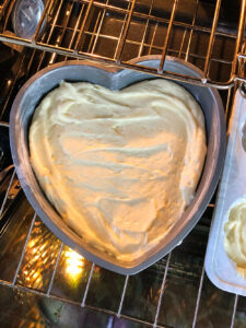 cake going into the oven to bake