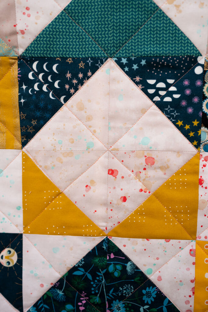 a quilt block with a light color diamond in the center