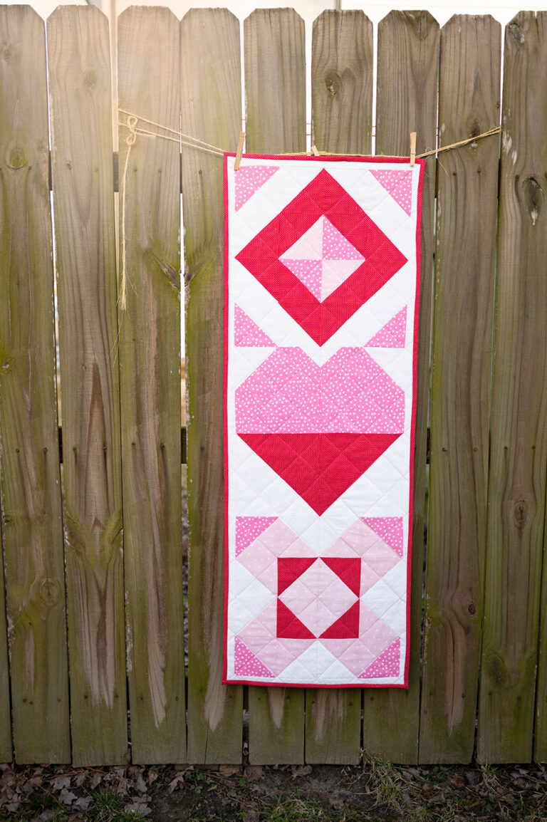 valentine table runner displayed on a rustic fence