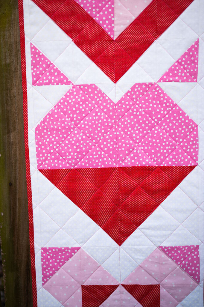 the heart quilt block as it appears in this quilted table runner