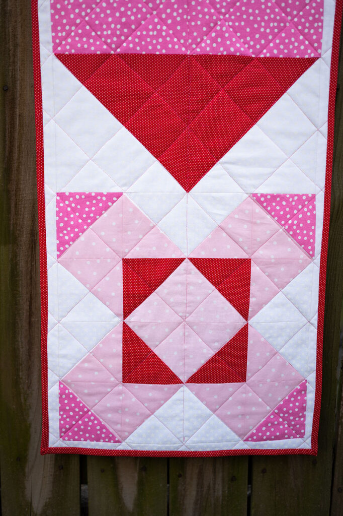 the ribbon quilt block as it appears in this quilted table runner