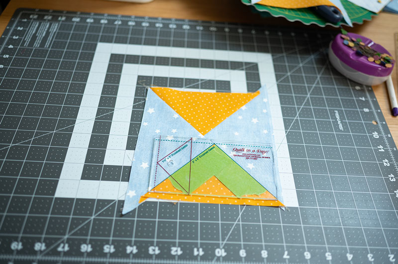 Using the quilt in a day ruler to trim flying geese unit