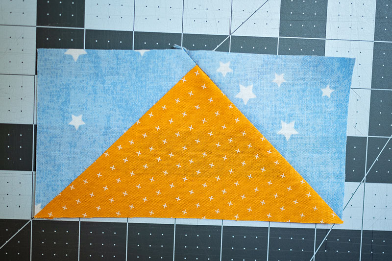 a perfect flying goose unit used in quilting. it has a golden goose and a blue sky