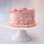 pink cake on a white cake stand