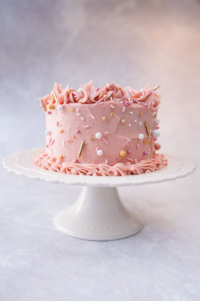 pink cake on a white cake stand