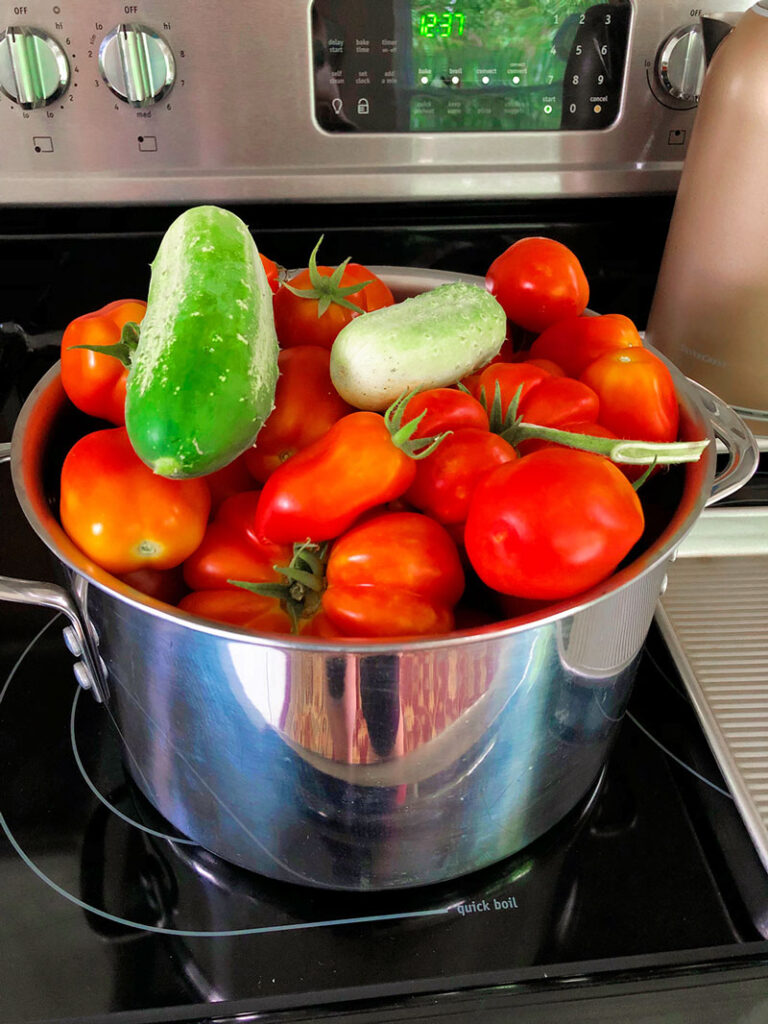 a stainless steel pot full of fresh garden produce