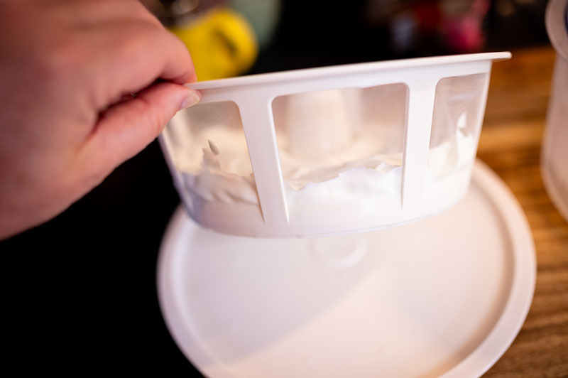 thickened yogurt in a strainer