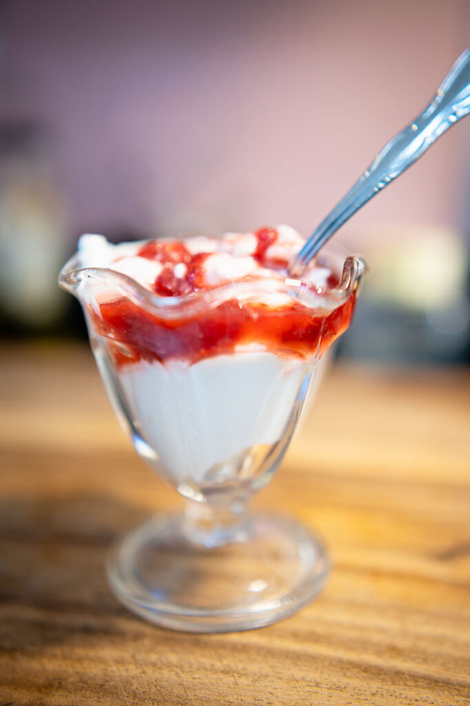 vintage parfait cup with yogurt and strawberry jam
