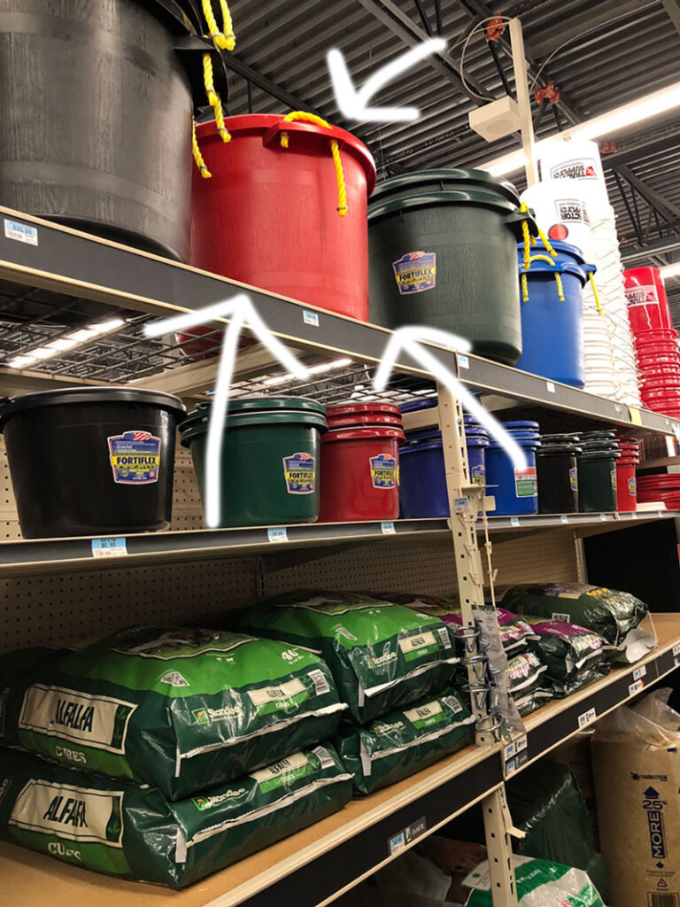 feed buckets on the top shelf in a tractor supply store
