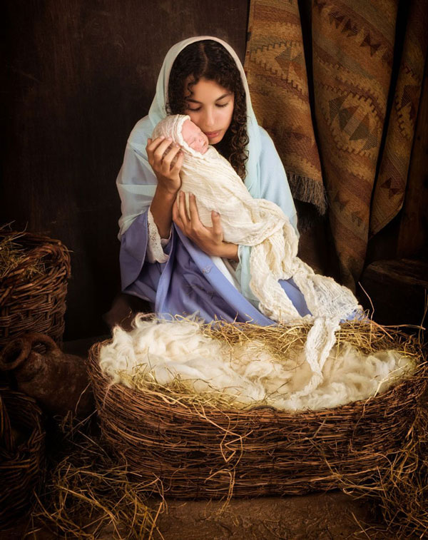 Mary holding baby Jesus in the stable