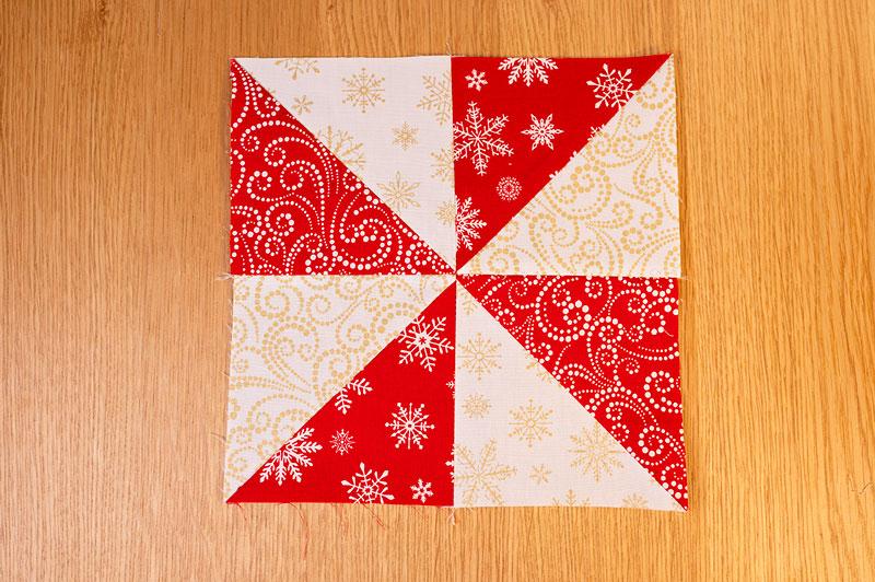 a red and white pinwheel block