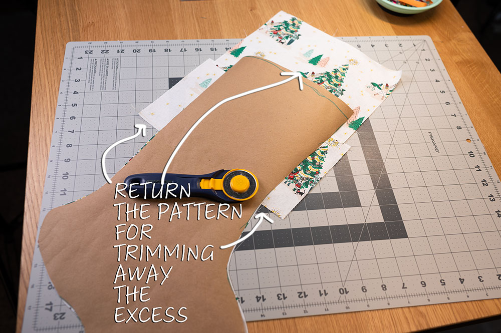 trimming away excess to reveal a pieced stocking panel