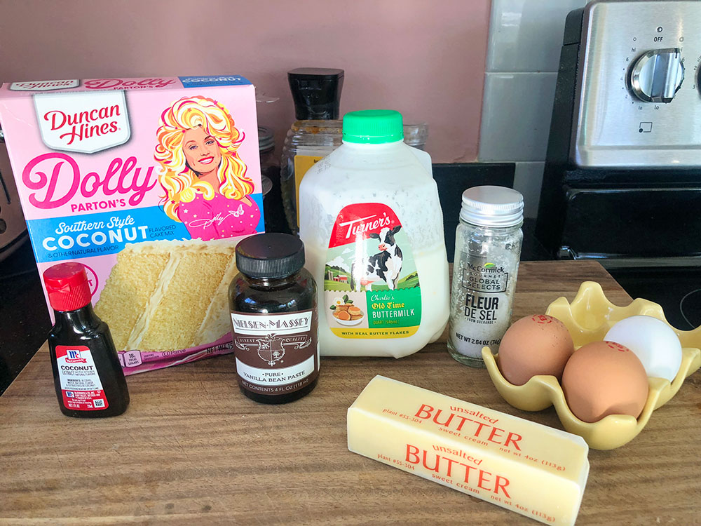 ingredients for a coconut cake including cake mix and butter milk and vanilla bean paste