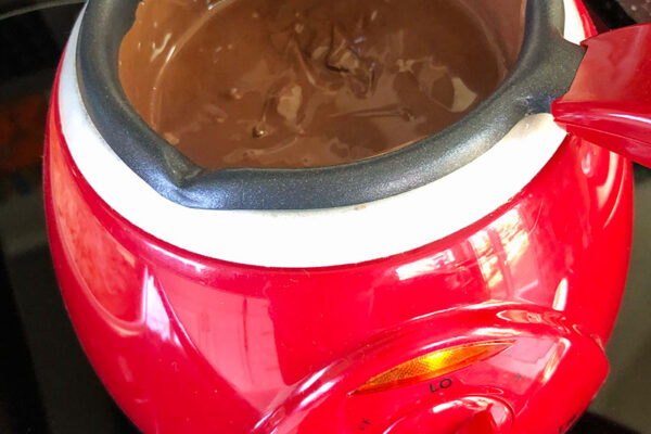 a chocolate pot with melted milk chocolate