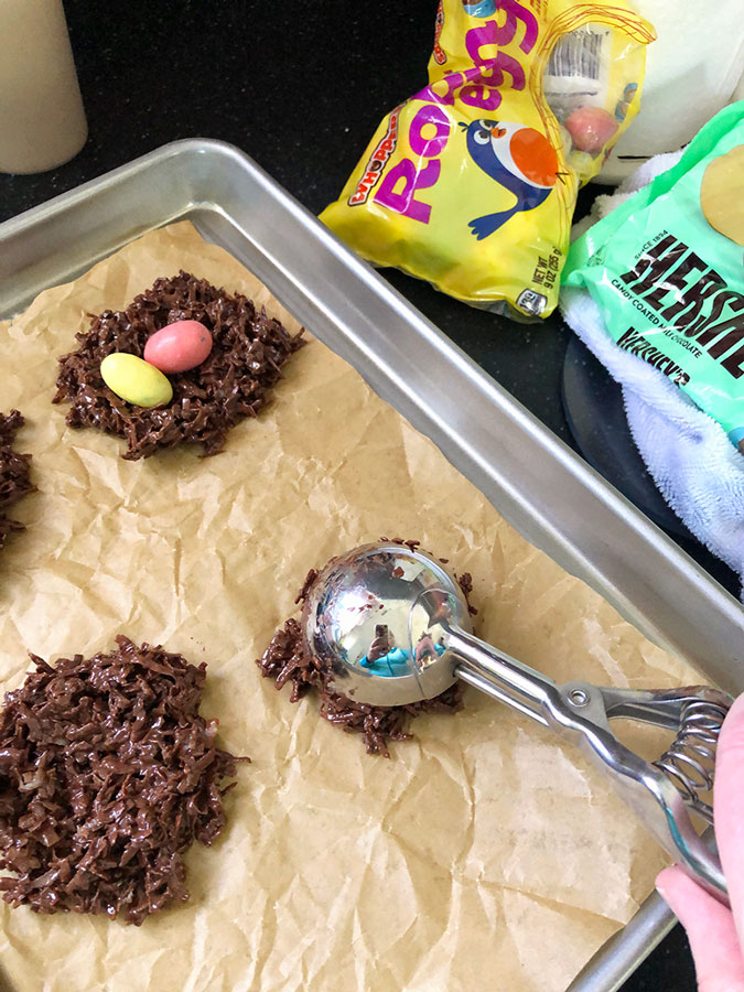 scooping chocolate mixture onto a cookie sheet