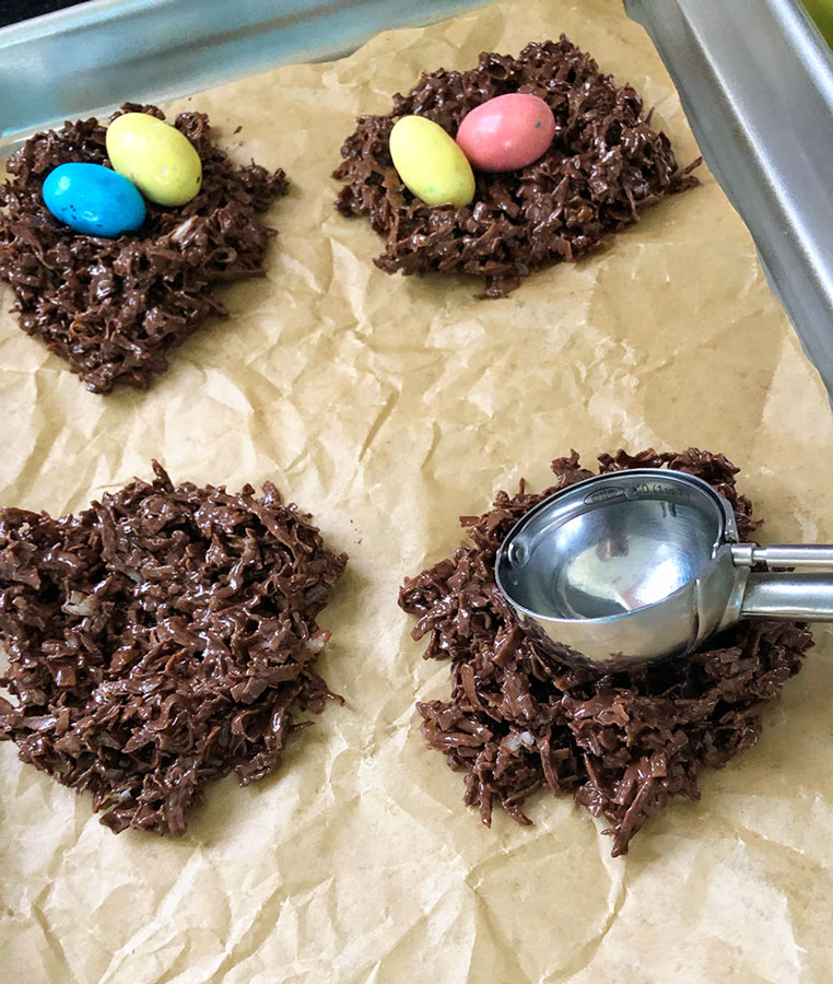 using the back of a cookie scoop to make an indentation in the chocolate "nest"