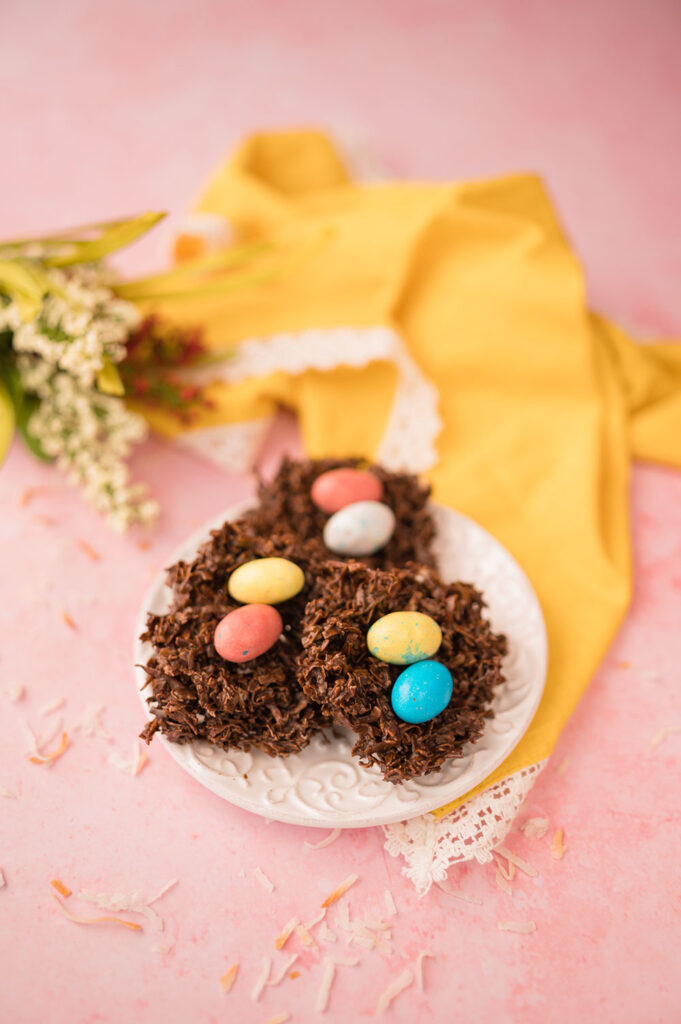 a small plate of chocolate coconut bird's nest cookies with colorful eggs