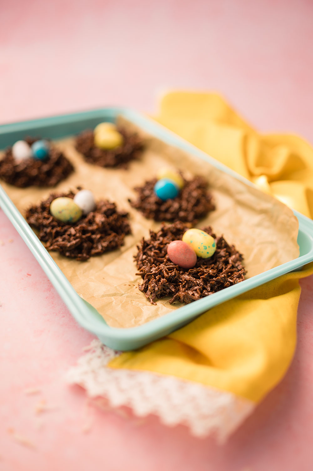a tray of chocolate covered coconut bird's next cookies