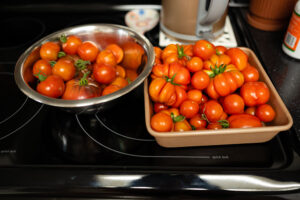 two large containers of fresh tomatoes