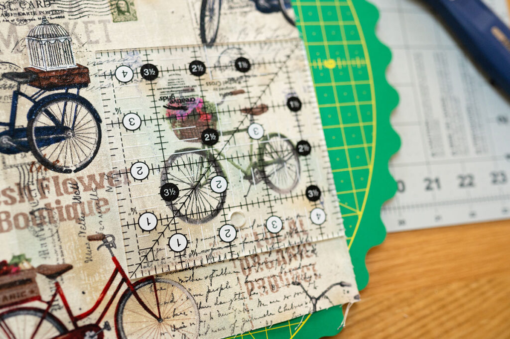 a quilt ruler lined up to fussy cut a bicycle motif