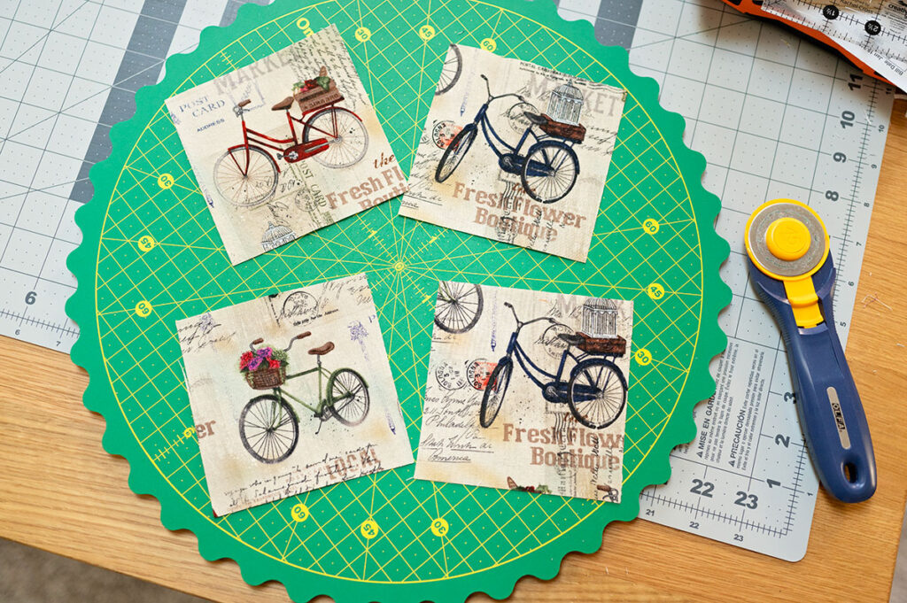 four squares of fabric cut to feature a bicycle prnt