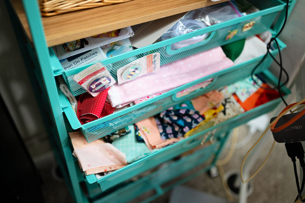 drawers in a cart pulled out to reveal a large collection of scrap fabrics
