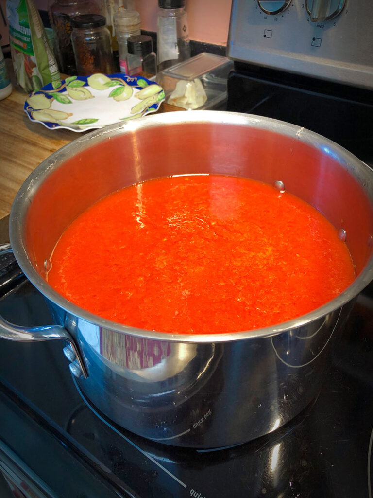 a stock pot full of tomato sauce cooking