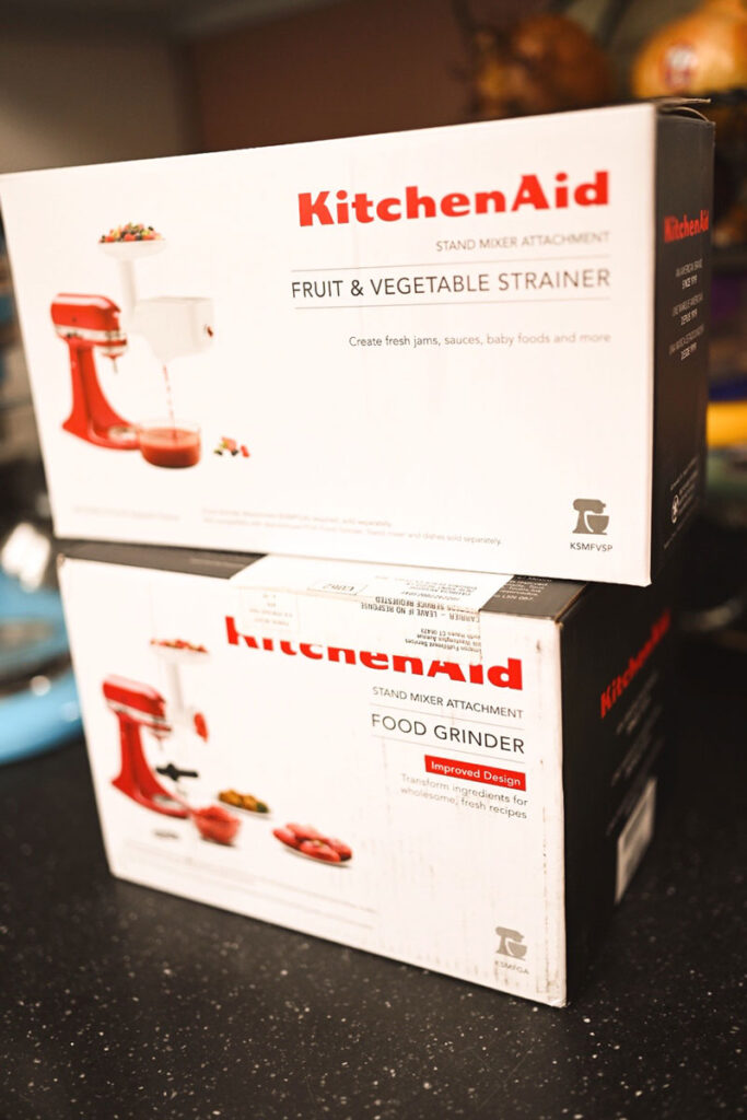 two boxes of kitchenaid equipment. the food grinder and mill attachment