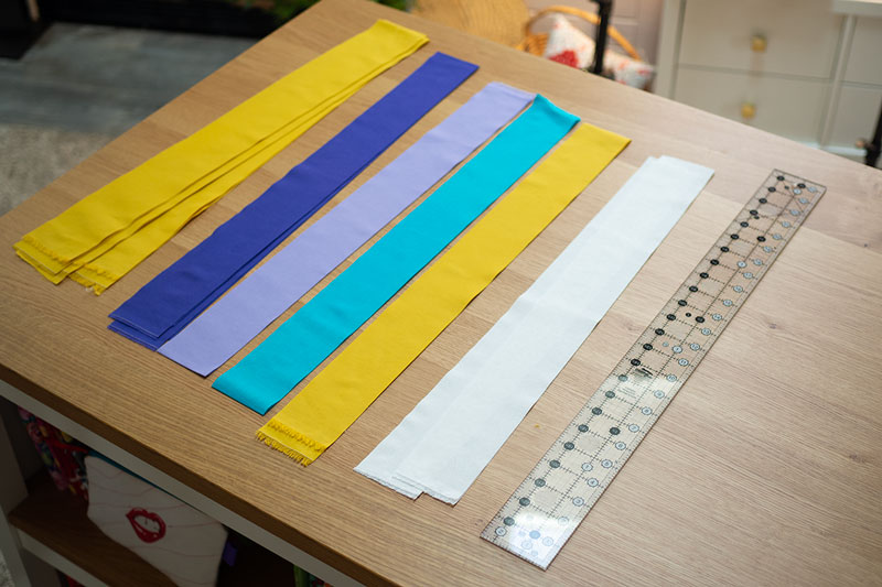 strips of colorful fabric on a table top