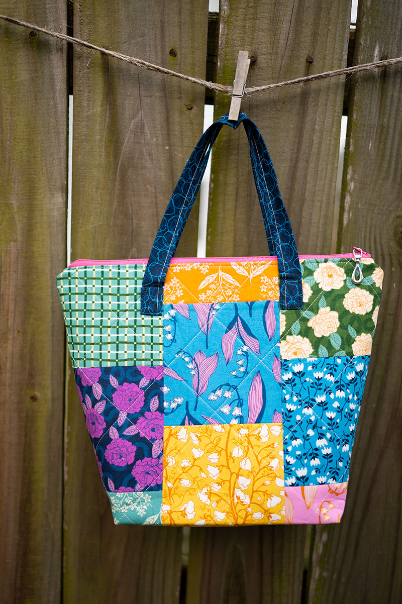 quilted patchwork quilted hand bag hanging on a clothesline