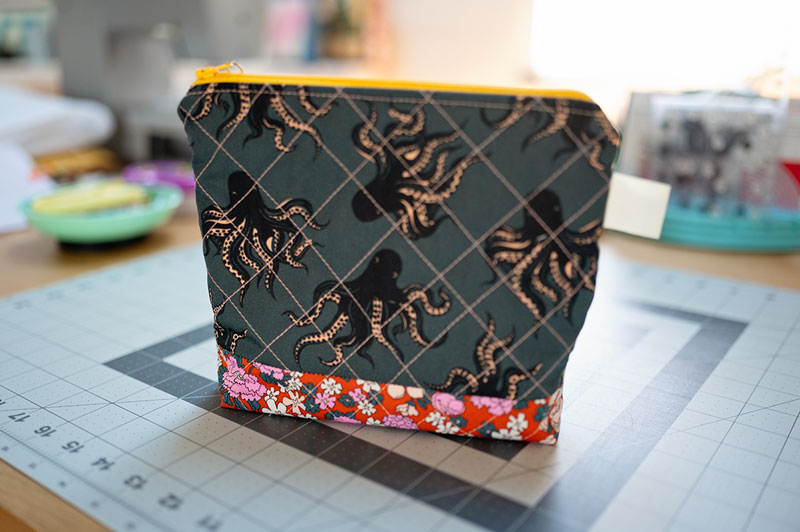 small zippered bag on a table top in a sewing room