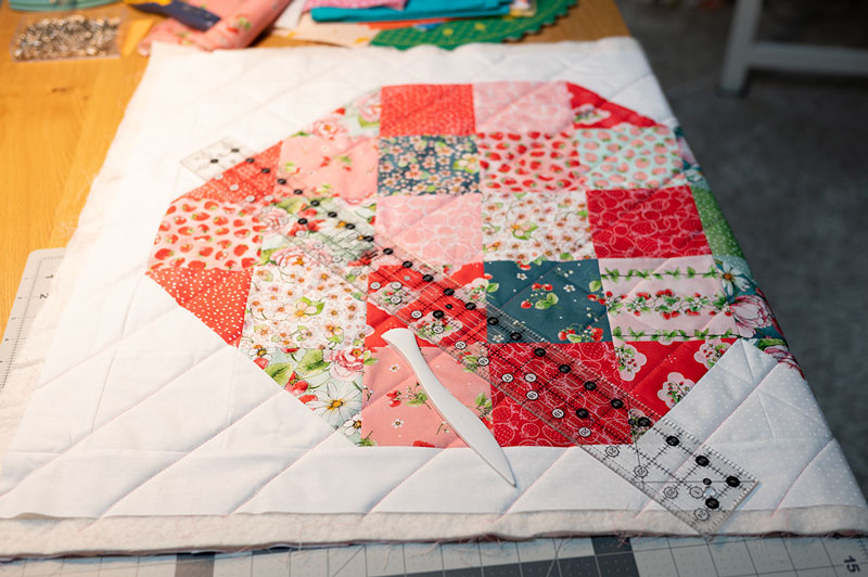 sandwiched quilt project being marked for quilting