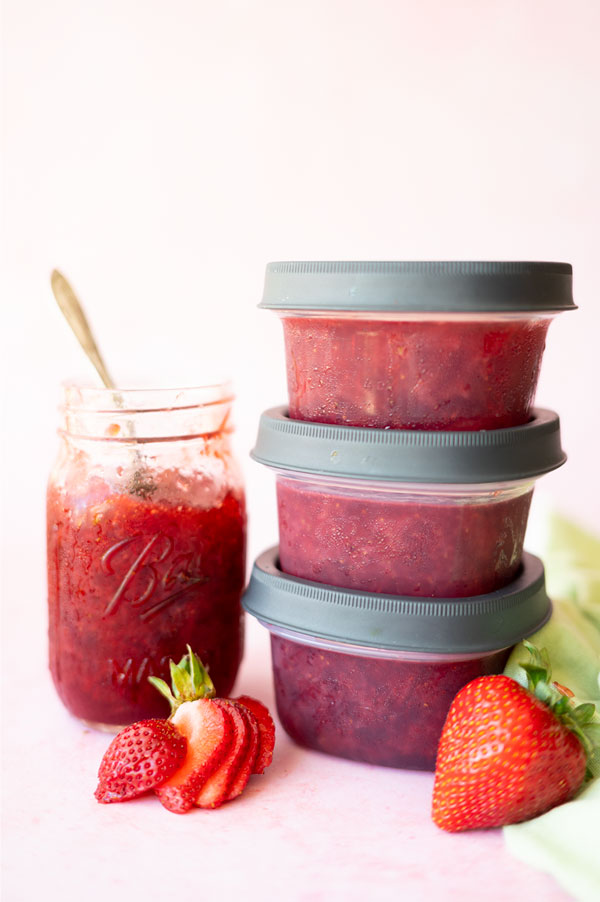 glass and plastic containers of strawberry jam